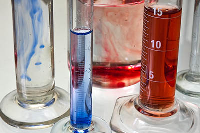 Transparent chemistry glass tubes filled with substances.