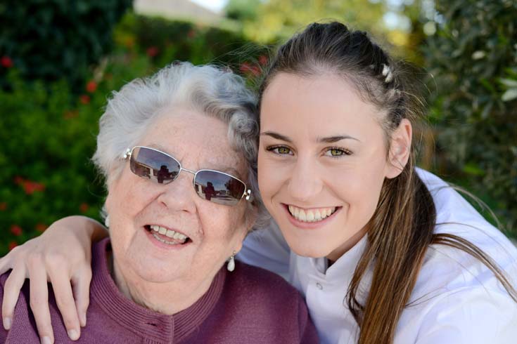 Young carer with elderly woman 