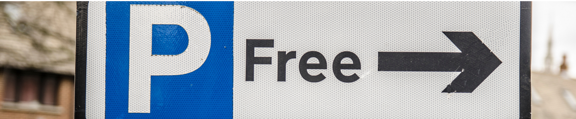A parking sign with the word 'free' and an arrow.