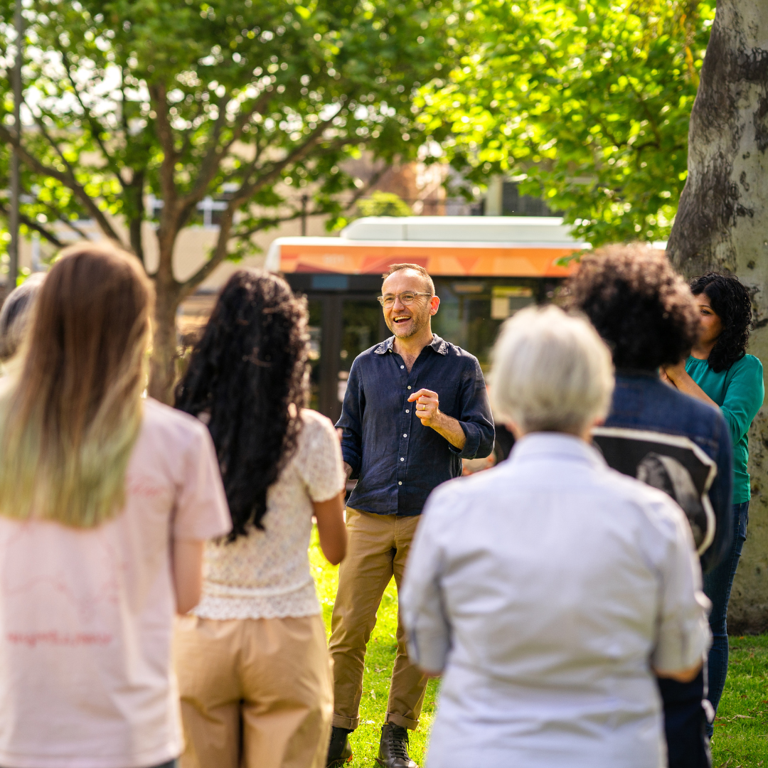 Adam speaking to community in Melbourne on a sunny day 