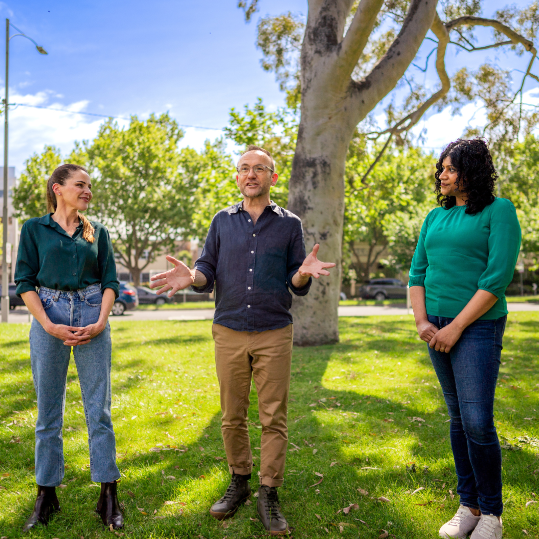 Picture of Sonya Semmens, Adam Bandt and Samantha Ratnam smiling together at Carlton Gardens in Melbourne