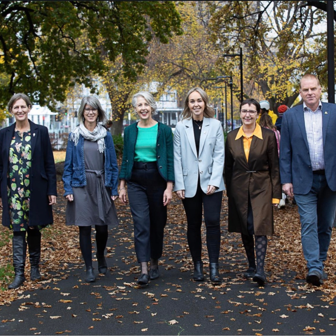 Rosalie Woodruff and Tasmanian Greens representatives walking together and smiling 