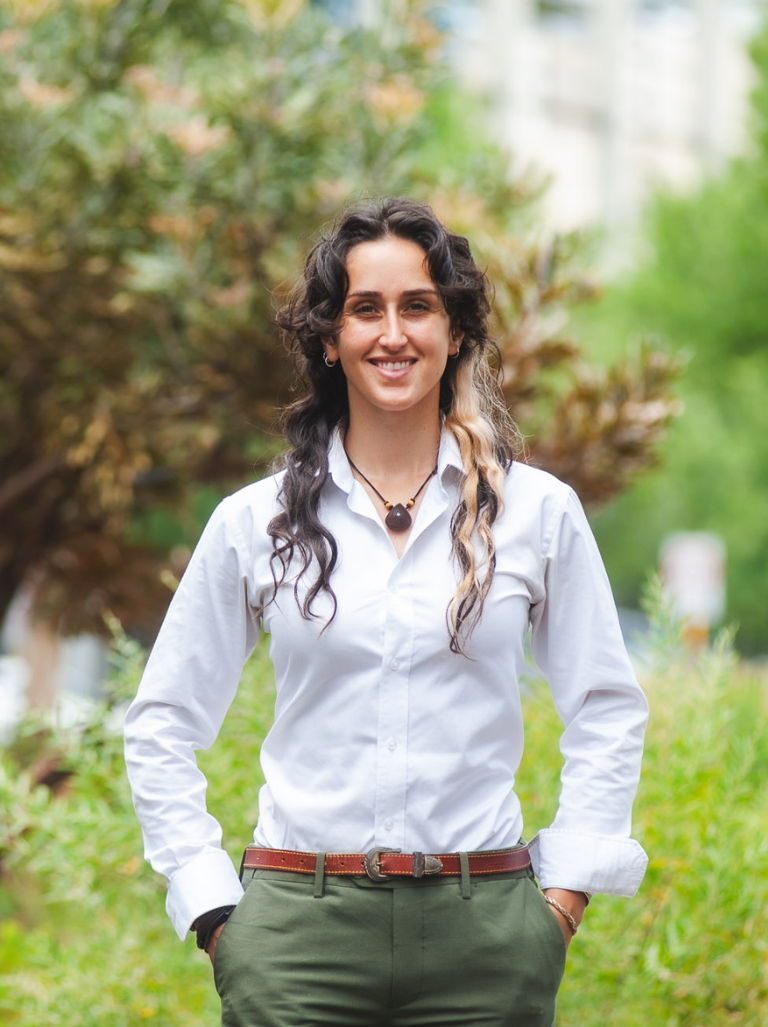 Mia Krasenstein wearing a white shirt, smiling at the camera