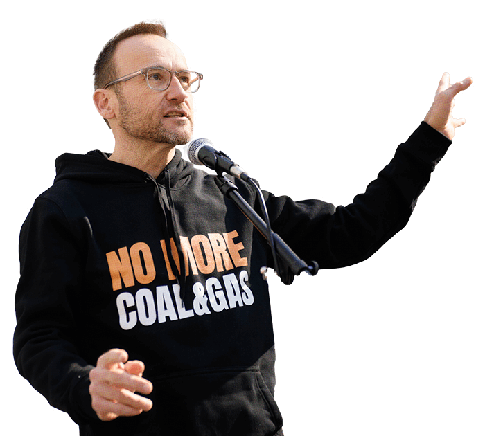 adam-cutout.png Adam Bandt wearing a hoodie that says 'No more coal and gas'
